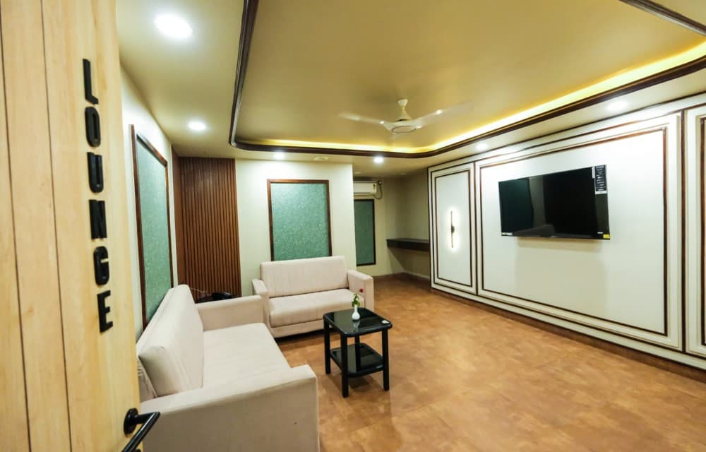 Relaxing guest lounge with comfortable seating at Hotel Prabhupada