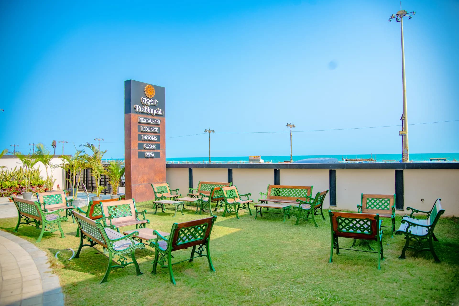 Lush landscaped open garden lawn facing New Marine Drive Puri