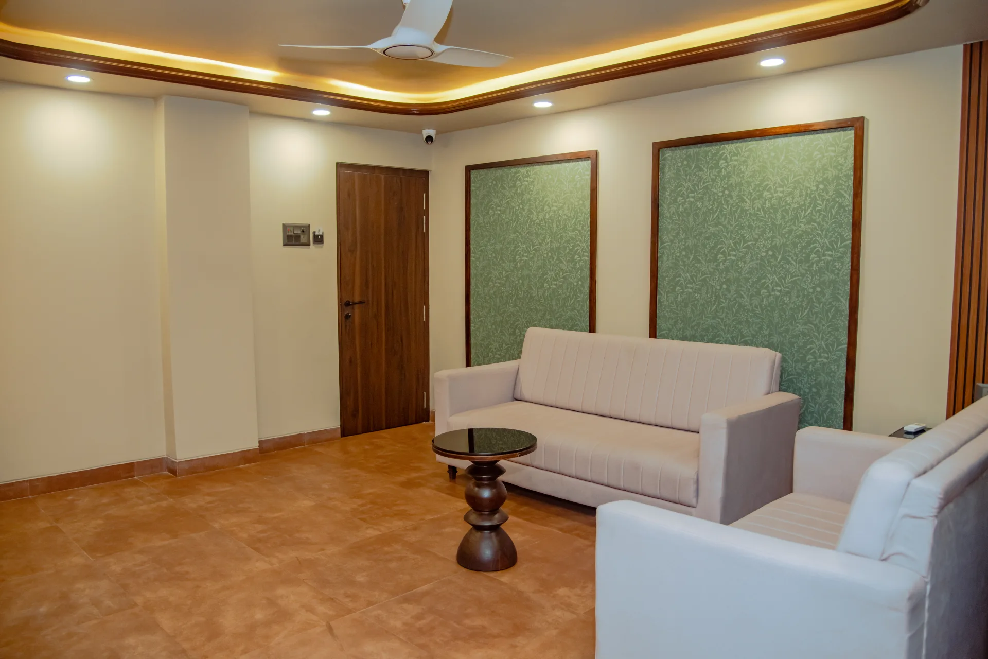 Relaxing guest lounge with comfortable seating at Hotel Prabhupada