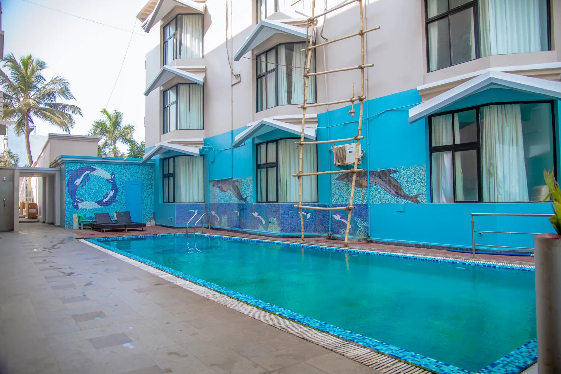 Outdoor swimming pool and sun deck at Hotel Prabhupada Puri